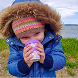 girl holding purple flower cup 