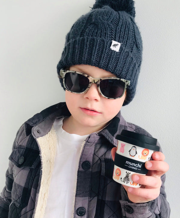 boy holding black and white animal zoo babycino cup