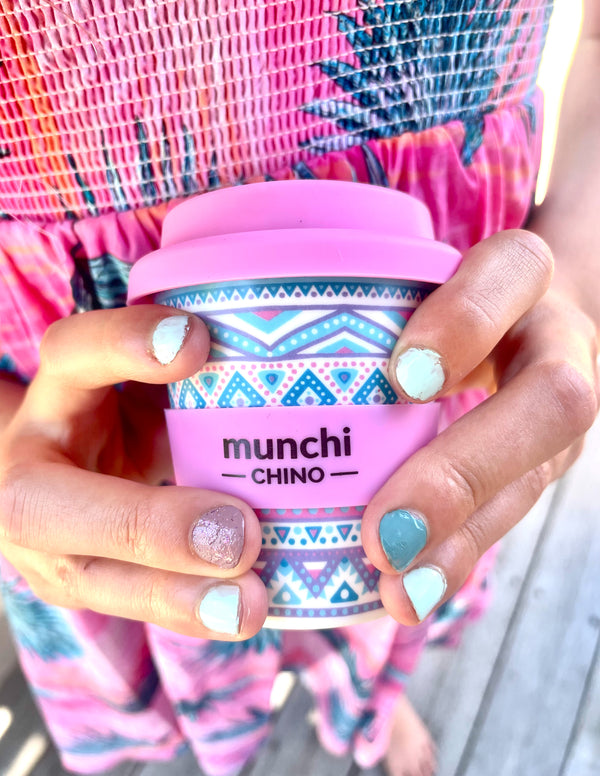 girl holding pink aztec babycino cup