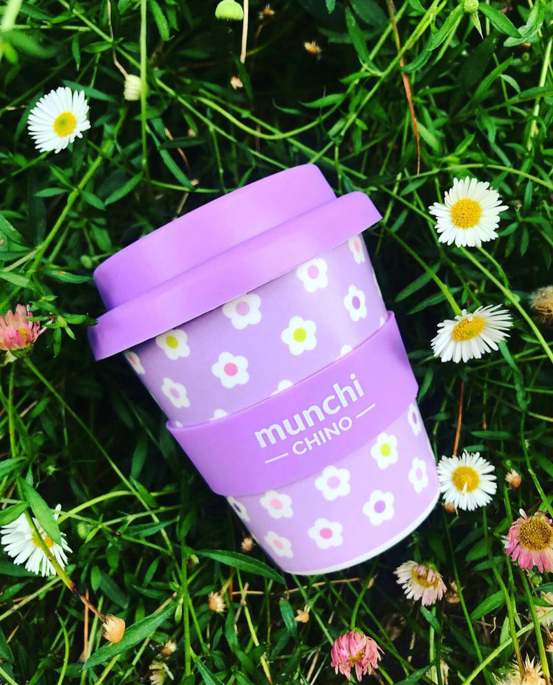 purple flower cup in field of daisies