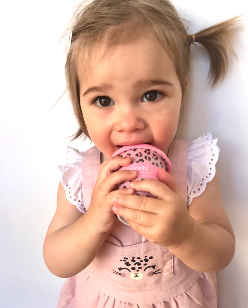 toddler girl drinking from pink leopard babyccino cup