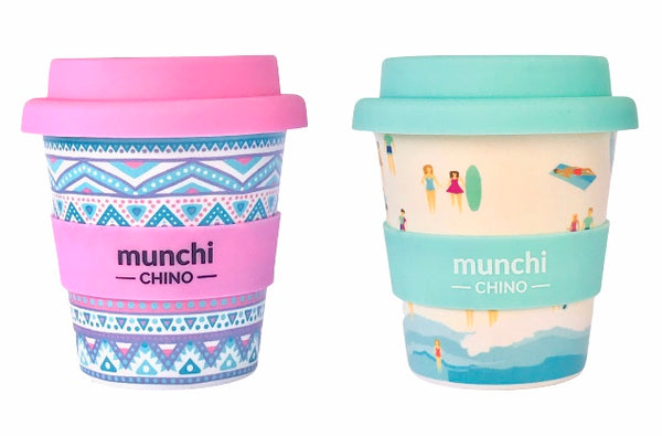 pink aztec babyccino cup and blue and green beach babychino cup with surfboards and people and waves